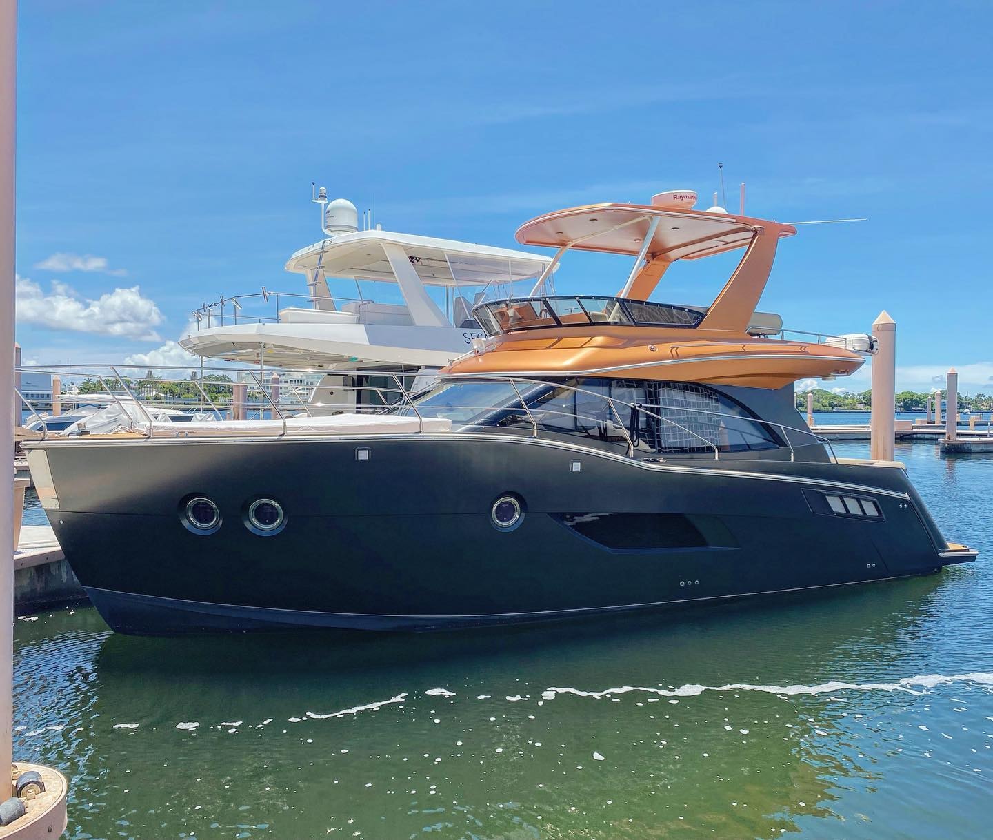 Luxury sport boat with custom cyan wrap